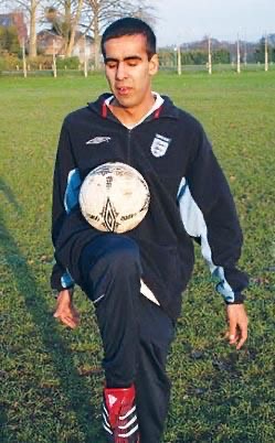 Aj, founder of VI Confidence Academy, controlling a football on his knee in an England Blind Football tracksuit.